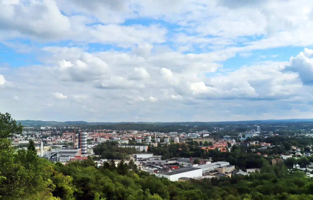 Panoramic view of Boras cityscape with industrial and residential areas under a cloudy sky in Sweden, highlighting its role as a textile and retail hub and leader in eco-friendly practices.