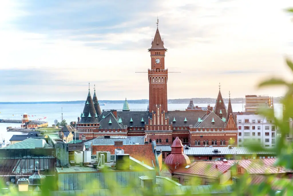 Panoramic view of Helsingborg City Hall with the Oresund Strait in the background, showcasing Sweden's historic architecture and coastal beauty.