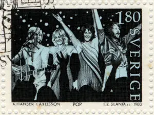 1983 Swedish postage stamp featuring iconic ABBA band members in a lively concert illustration, celebrating their pop music legacy.