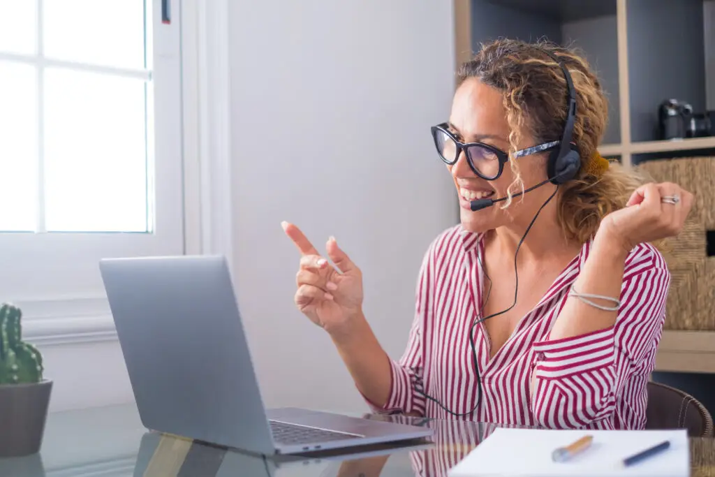 Attractive caucasian woman working as a virtual tour guide for Sweden Private Tours, engaging with clients from her home office
