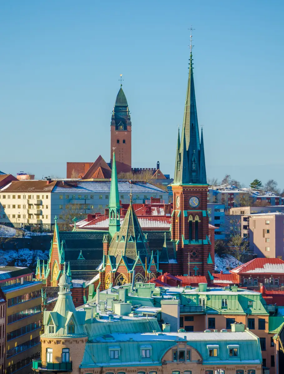 Winter view of colorful churches and historical rooftops in Gothenburg, Sweden, showcasing the city's architectural beauty and cultural heritage.